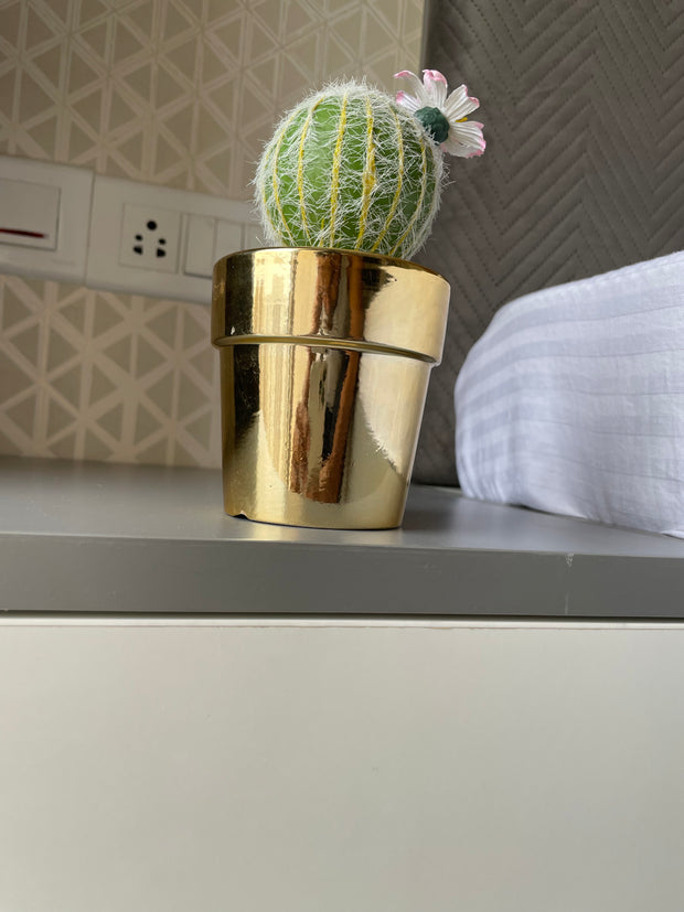 GOLDEN CERAMIC PLANTER WITH ARTIFICIAL LEAVES
